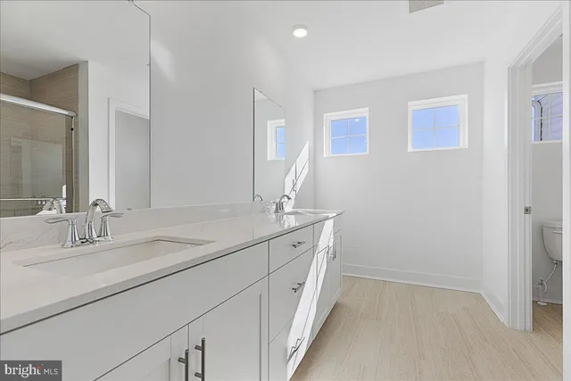 a bathroom with a double vanity sink and a mirror