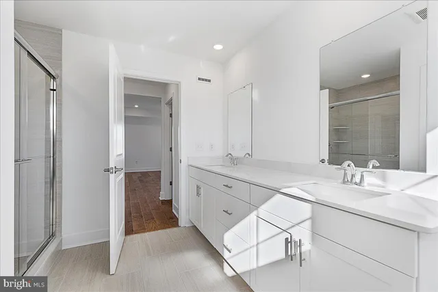 a spacious bathroom with a granite countertop sink a mirror and a