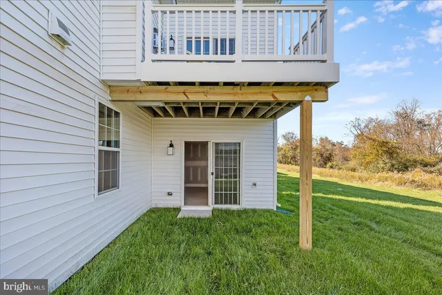 a view of a house with a big yard and large trees