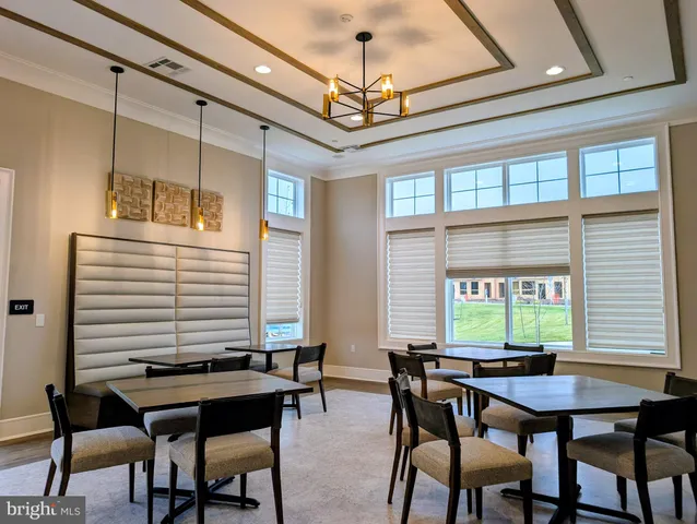 a living room with furniture and large windows