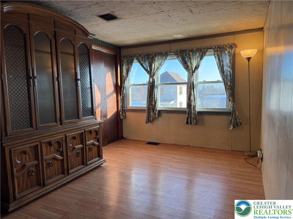 702 West Locker Street Nazareth, PA 18064 - Photo 6 of 12 an empty room with wooden floor mirror and windows