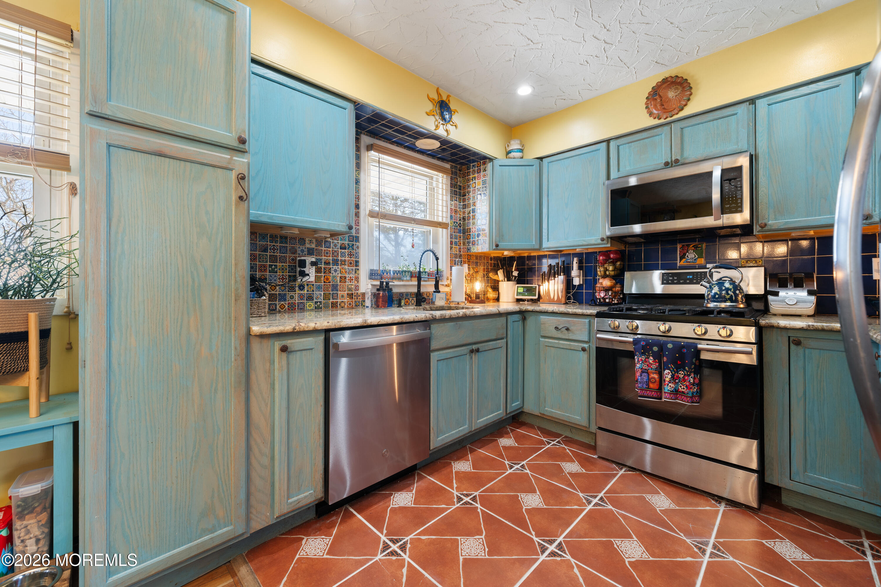 330 Riviera Drive Forked River, NJ 08731 - Photo 16 of 32 a kitchen with stainless steel appliances granite countertop a stove a sink and a microwave