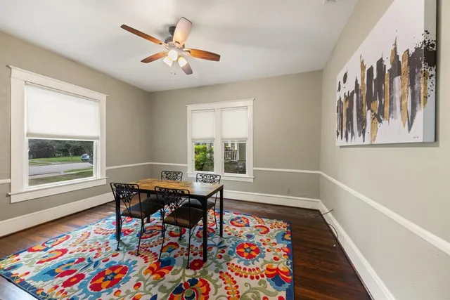 a dining room with wooden floor and a table