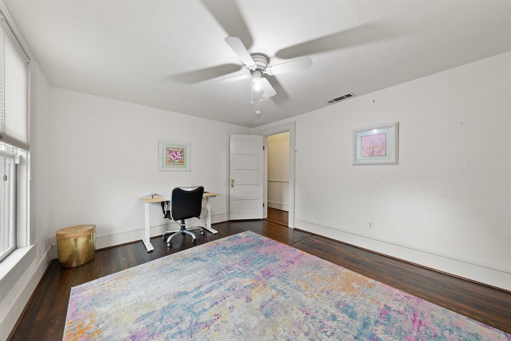 5502 Victor Street Dallas, TX 75214 - Photo 18 of 22 a bedroom with a bed and a chandelier