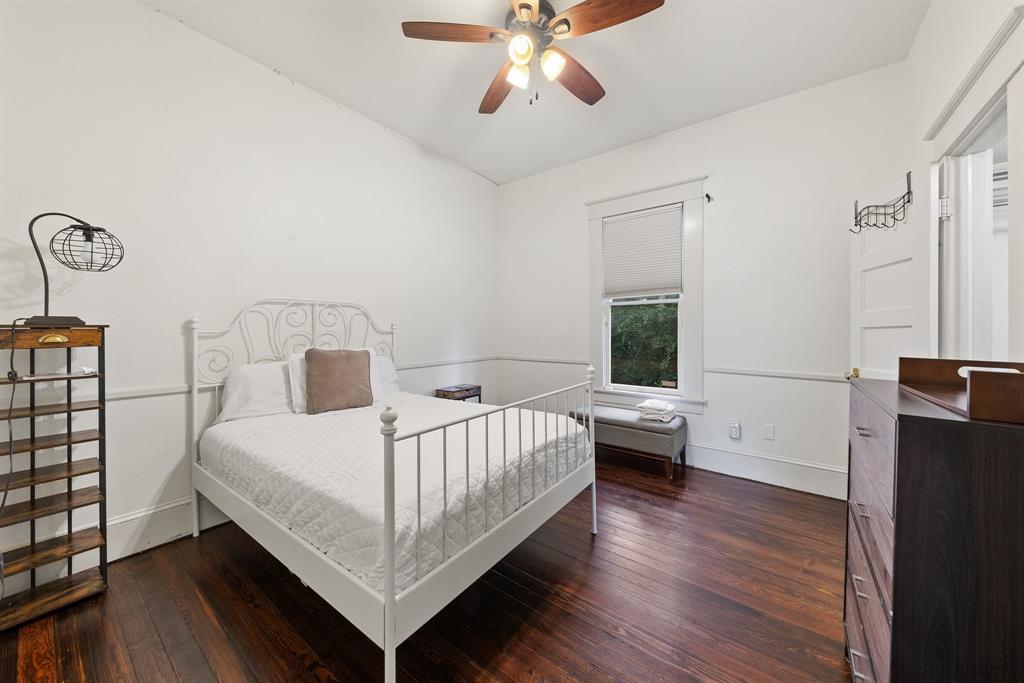 5502 Victor Street Dallas, TX 75214 - Photo 19 of 22 a bedroom with a bed and a chandelier