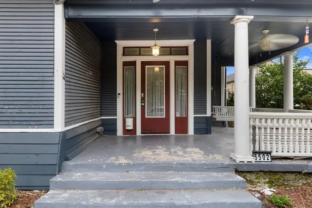 a view of front door and porch with wooden floor