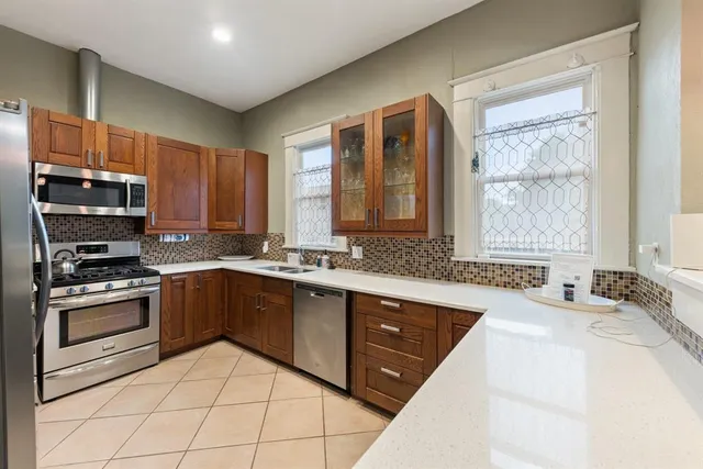 a kitchen with a sink stove and cabinets