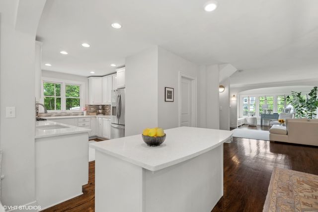 a kitchen with a sink and living room