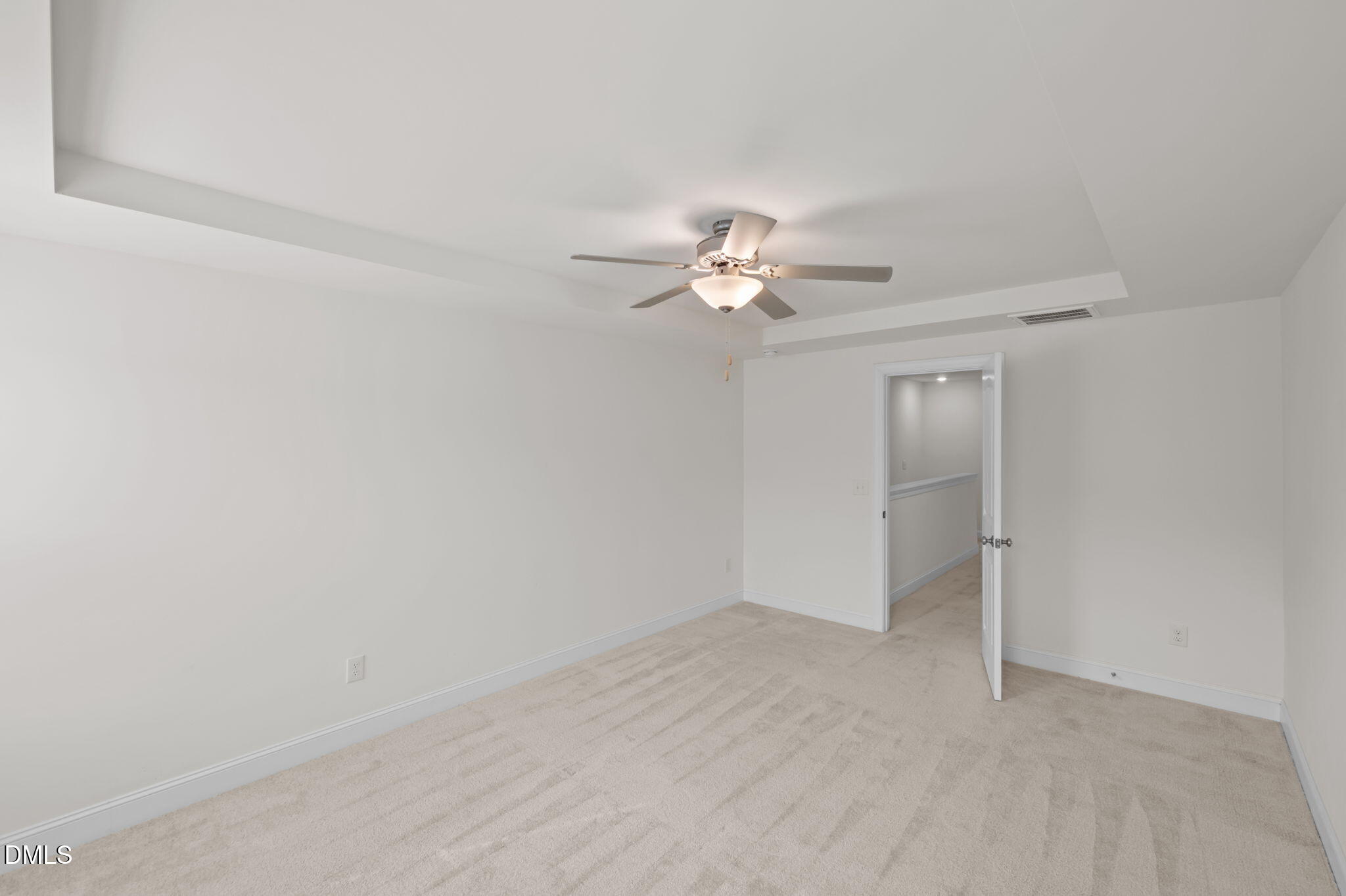 1033 Heartstone Way Durham, NC 27713 - Photo 12 of 26 an empty room with a chandelier fan