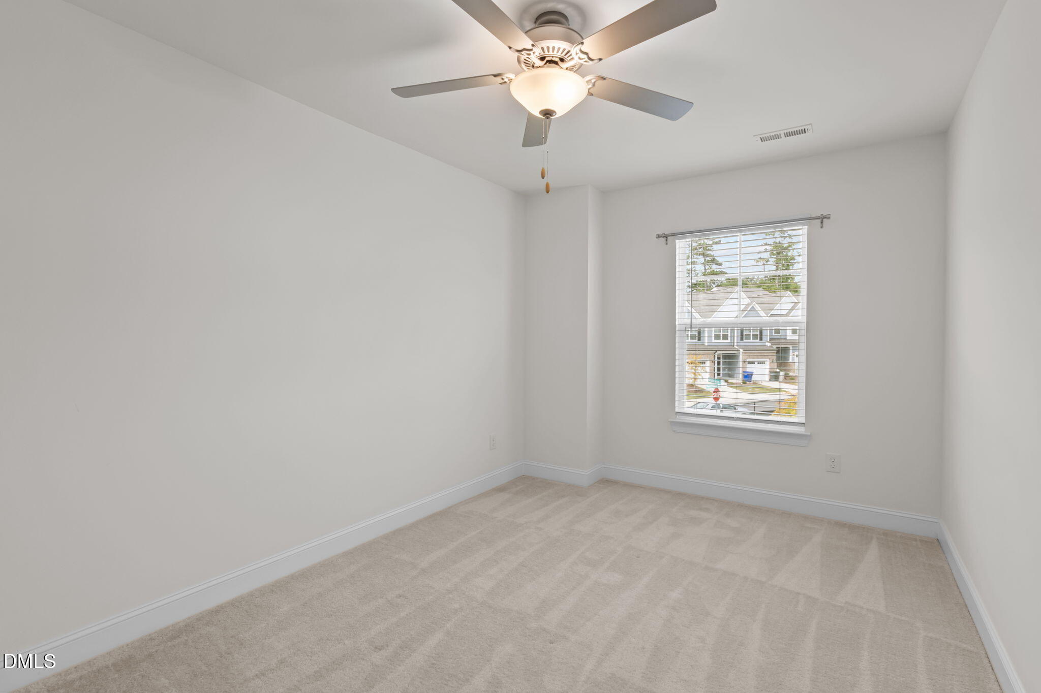 1033 Heartstone Way Durham, NC 27713 - Photo 17 of 26 an empty room with a window and a fan