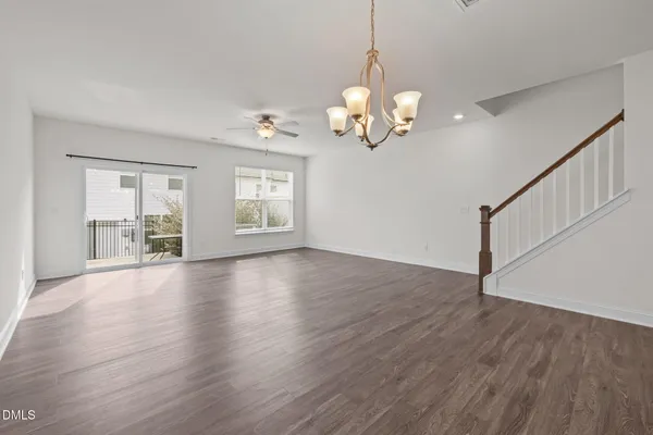 a view of a livingroom with wooden floor and a window