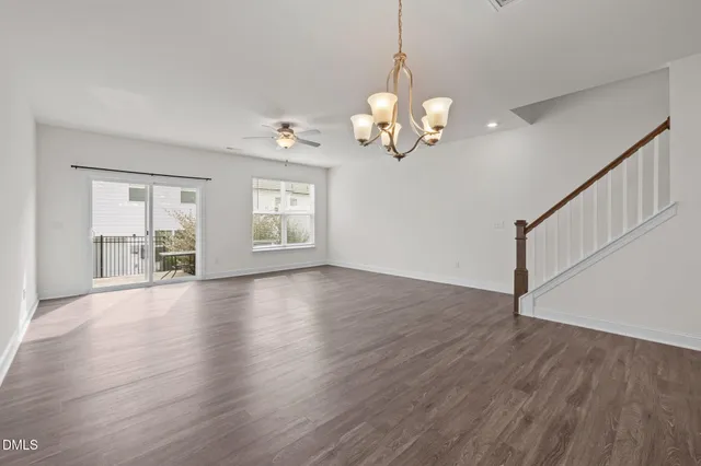 a view of a livingroom with wooden floor and a window