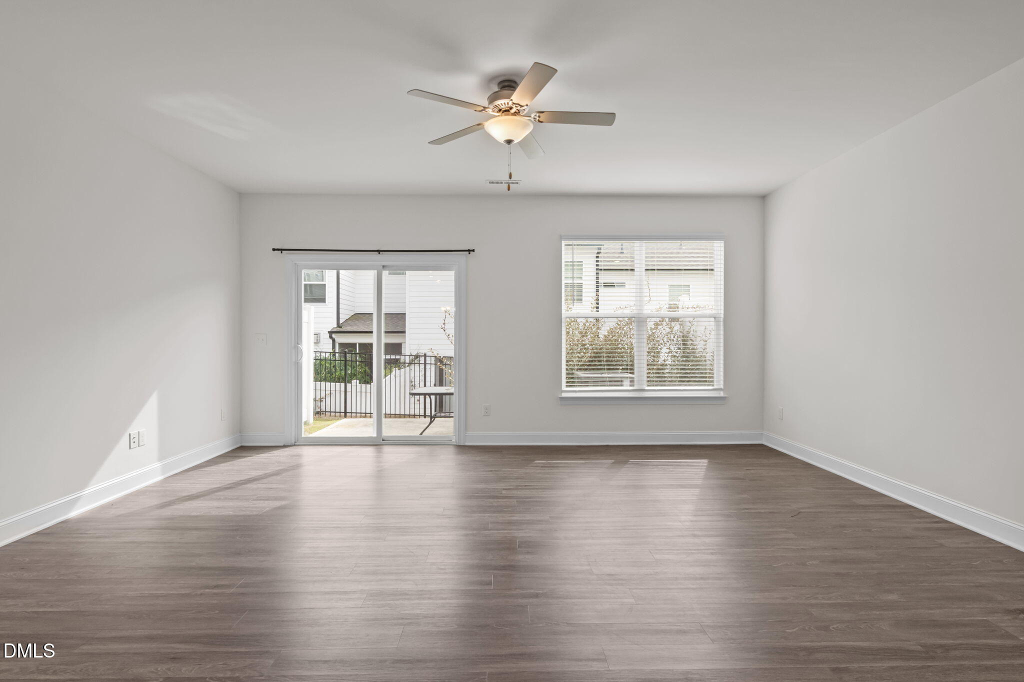1033 Heartstone Way Durham, NC 27713 - Photo 6 of 26 a view of an empty room with a window and wooden floor