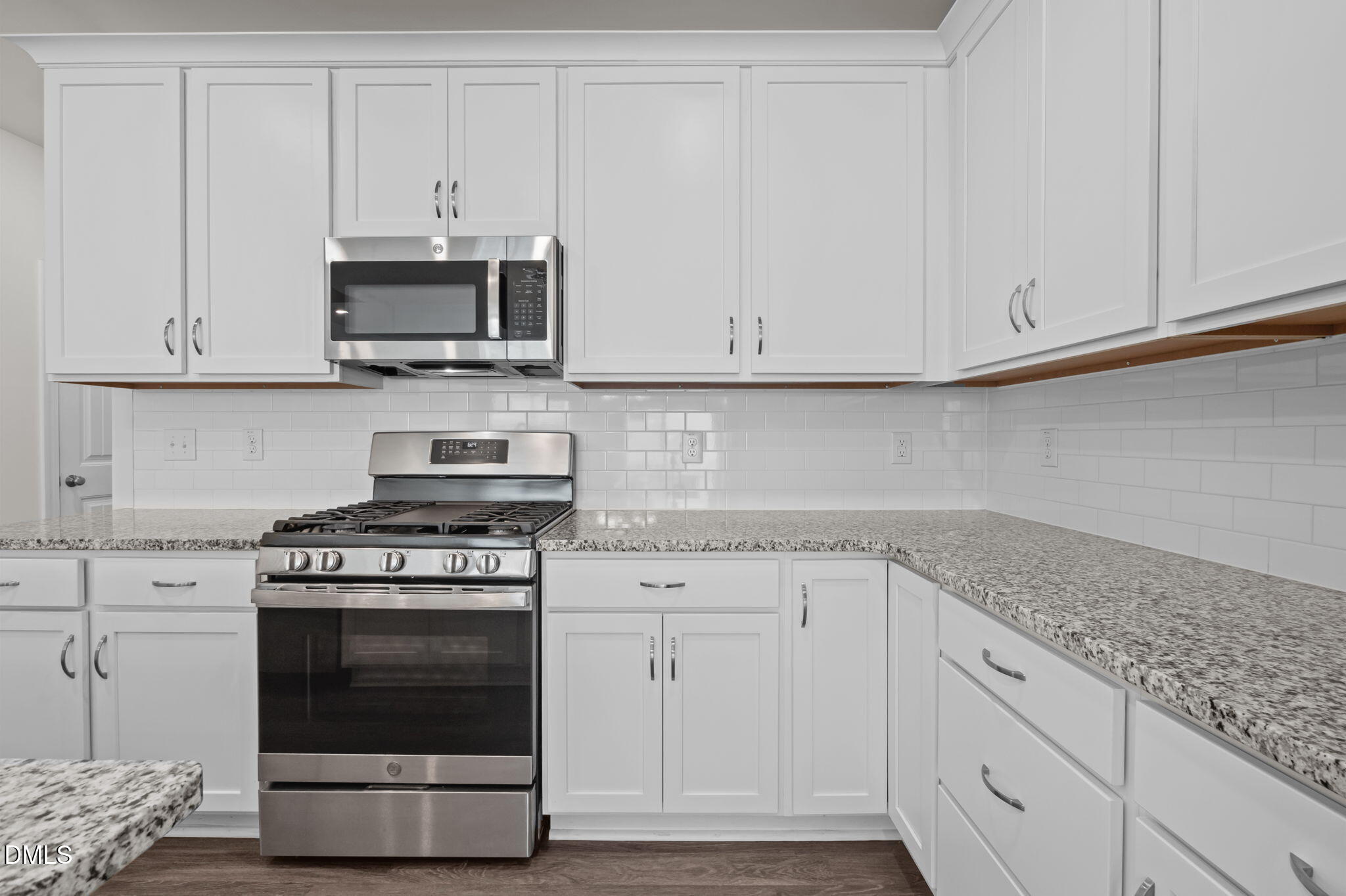 1033 Heartstone Way Durham, NC 27713 - Photo 10 of 26 a kitchen with stainless steel appliances granite countertop white cabinets and a stove