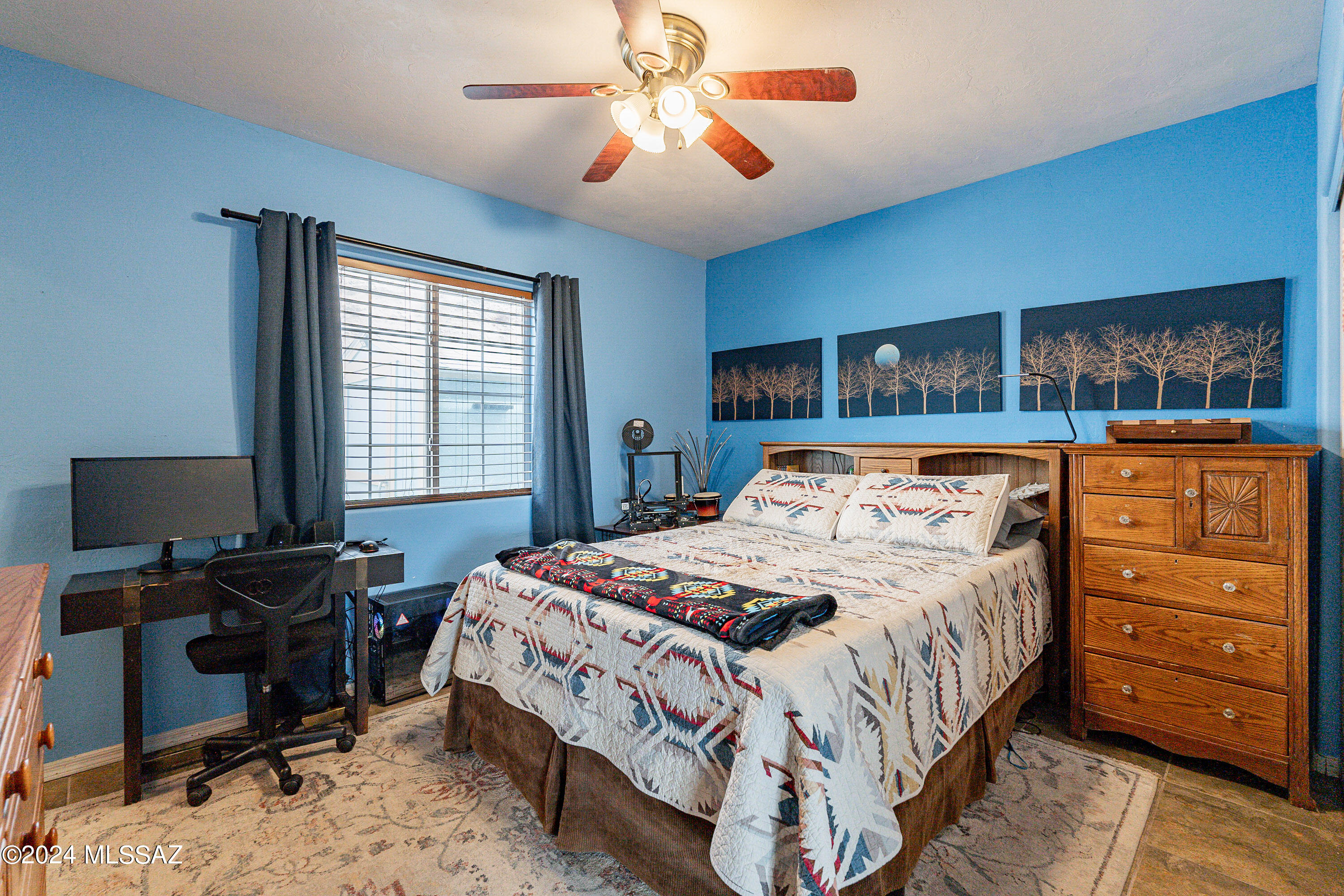 456 Camino Providencia Rio Rico, AZ 85648 - Photo 25 of 45 a bedroom with a bed and a chandelier