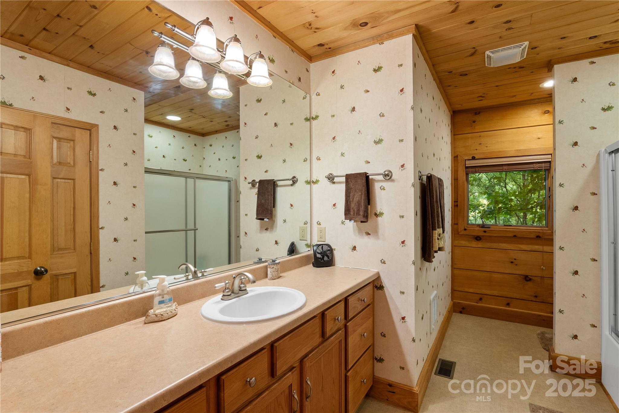 12215 Big Laurel Road Marshall, NC 28753 - Photo 17 of 44 a bathroom with double vanity and a shower