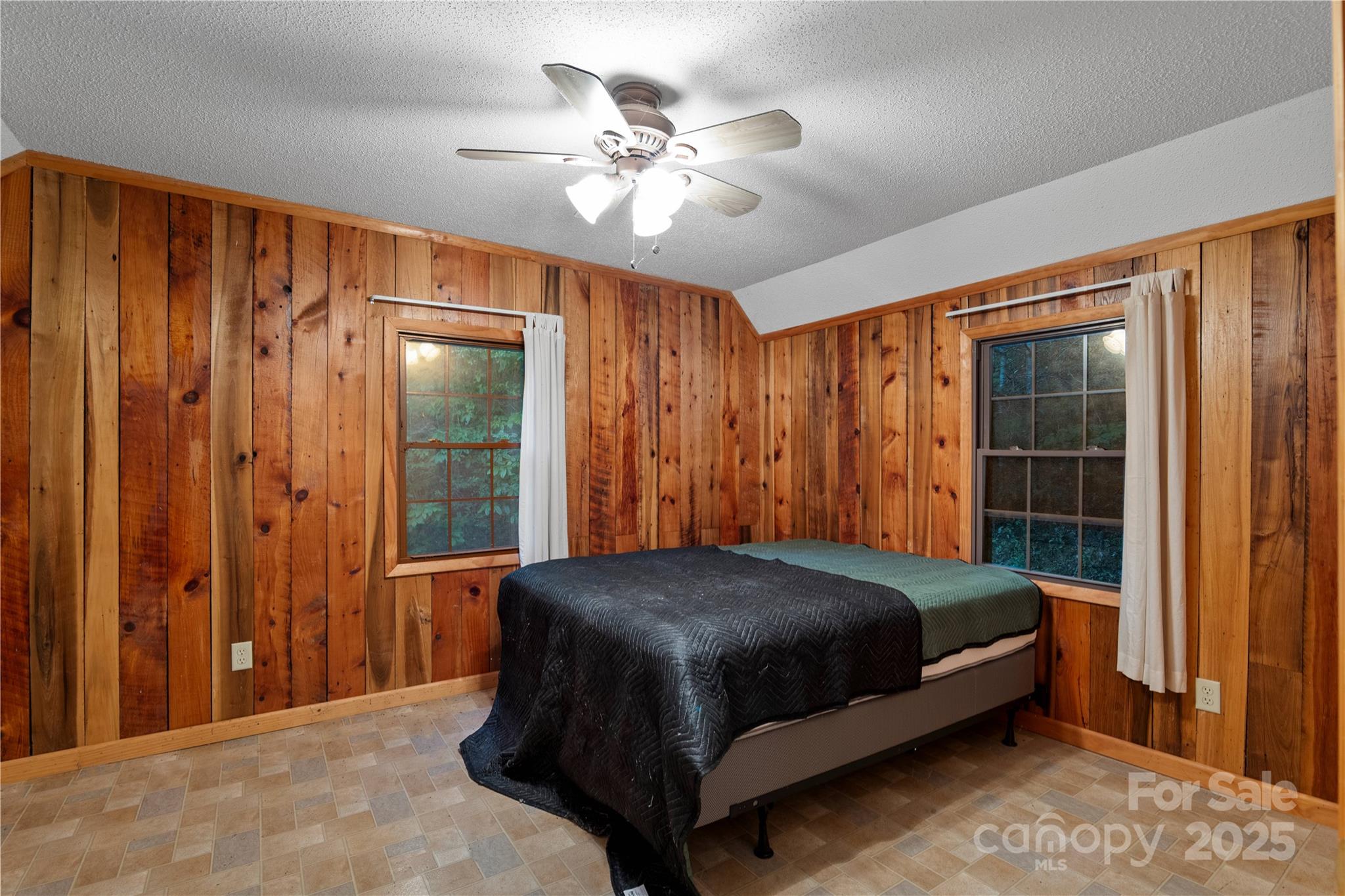 12215 Big Laurel Road Marshall, NC 28753 - Photo 36 of 44 a bedroom with a bed and a chandelier