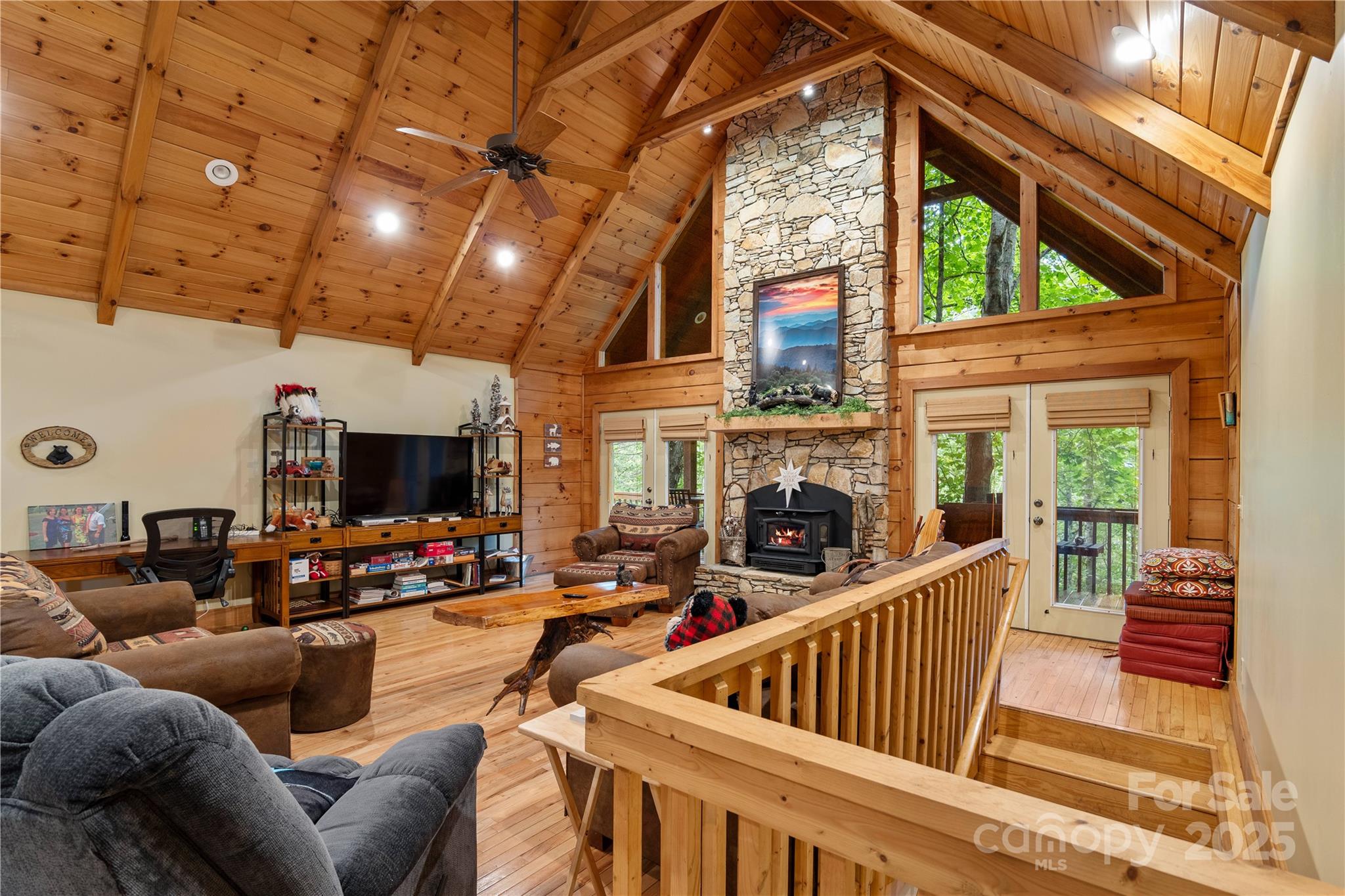 12215 Big Laurel Road Marshall, NC 28753 - Photo 7 of 44 a living room with furniture a flat screen tv and a floor to ceiling window