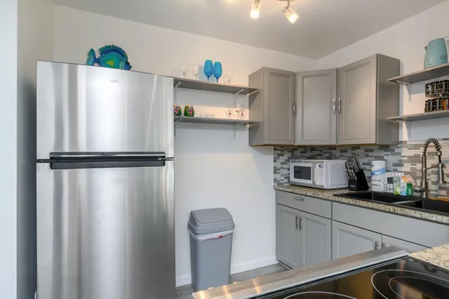 a kitchen with stainless steel appliances a refrigerator and a sink