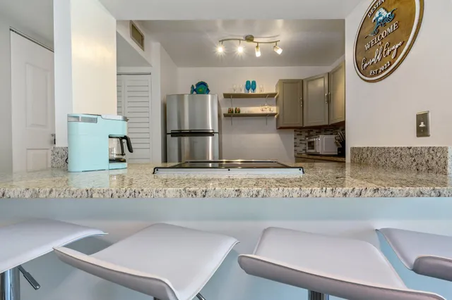 a view of kitchen with furniture and a chandelier
