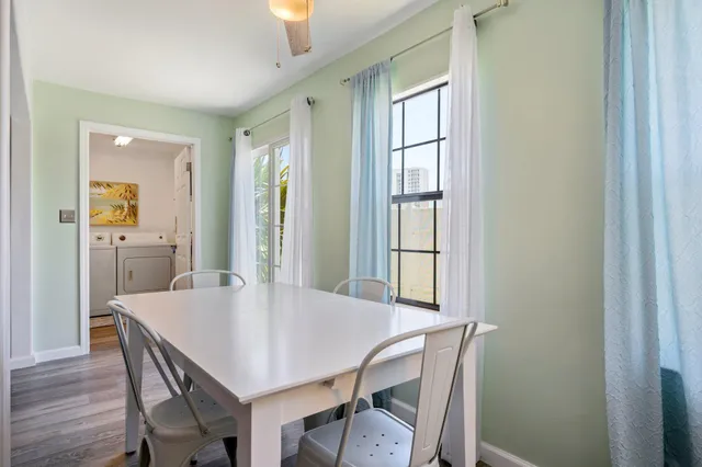 a view of a dining room with furniture and wooden floor