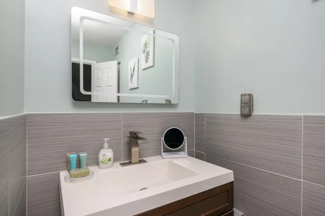 a bathroom with a sink and a mirror