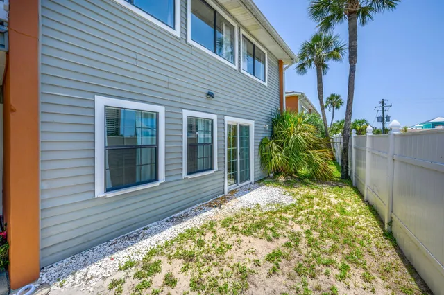 a view of a house with a small yard and plants