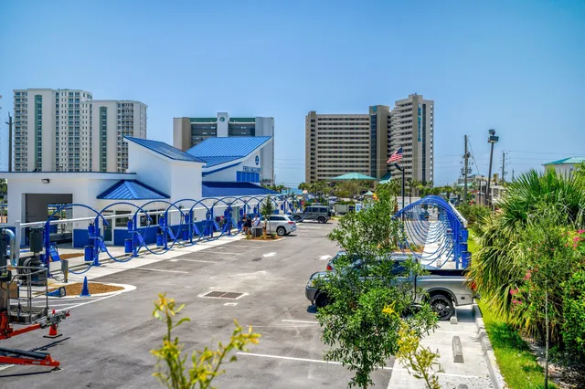 a flower garden and potted plants in front of the house