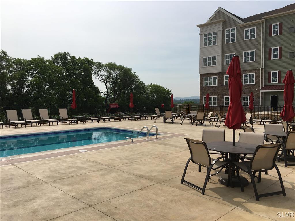 311 Robert Morris Boulevard, Unit 4 Allentown, PA 18104 - Photo 4 of 7 a swimming pool with outdoor seating and covered with trees
