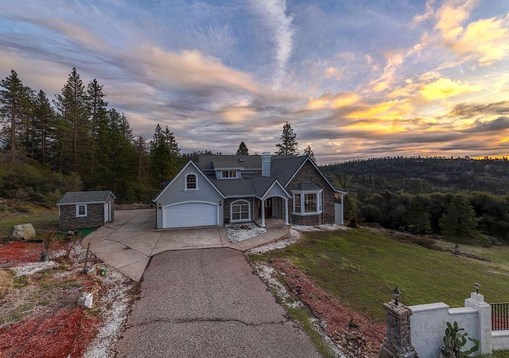 10246 Ranch Road Rough and Ready, CA 95975 - Photo 1 of 69 a front view of a house with a garden