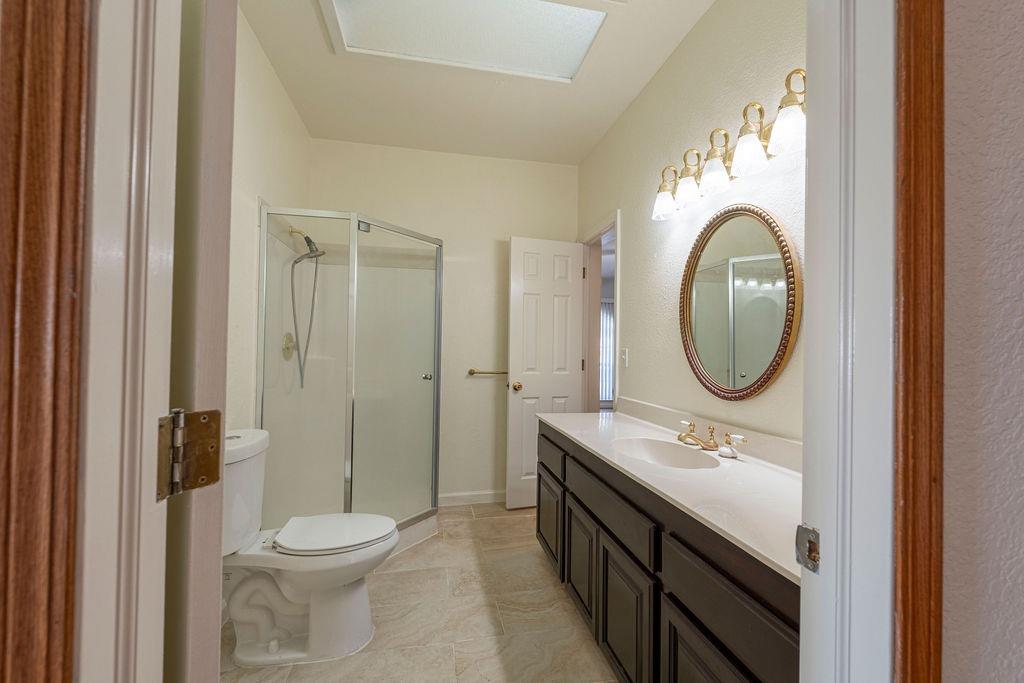 10246 Ranch Road Rough and Ready, CA 95975 - Photo 24 of 69 a bathroom with a double vanity sink toilet mirror and shower