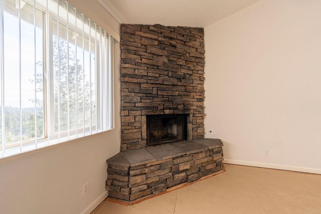 10246 Ranch Road Rough and Ready, CA 95975 - Photo 37 of 69 a living room with furniture and a fireplace