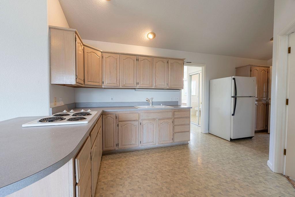 10246 Ranch Road Rough and Ready, CA 95975 - Photo 41 of 69 a kitchen with a stove a sink and a refrigerator