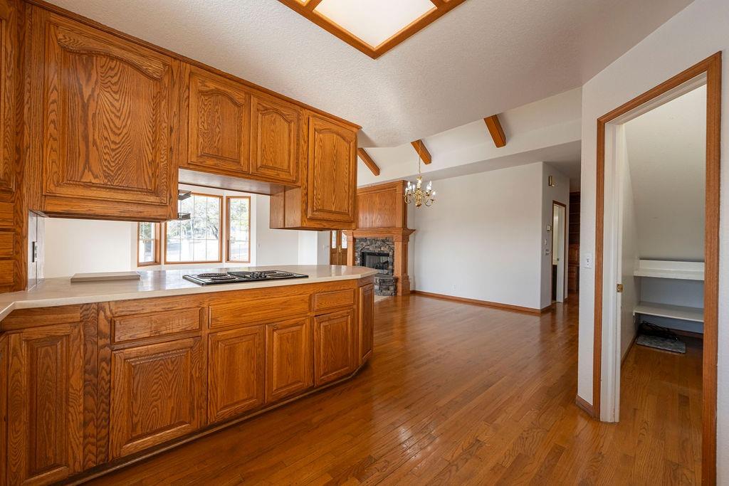 10246 Ranch Road Rough and Ready, CA 95975 - Photo 9 of 69 a kitchen with stainless steel appliances granite countertop a refrigerator a sink dishwasher and wooden cabinets with wooden floor