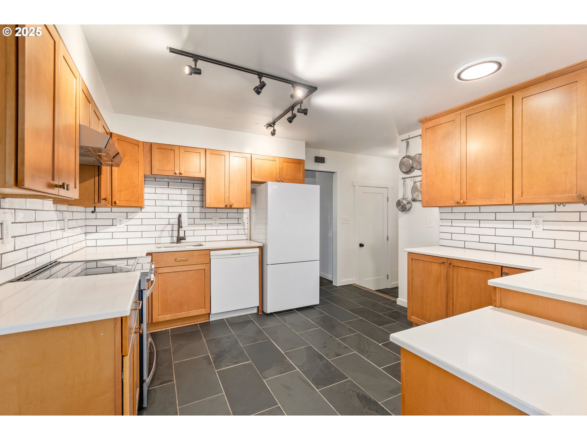 2765 Kismet Way Eugene, OR 97405 - Photo 15 of 46 a kitchen with a refrigerator a stove top oven a sink dishwasher and wooden cabinets
