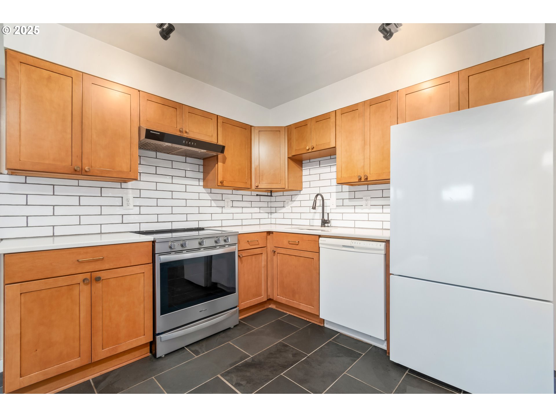 2765 Kismet Way Eugene, OR 97405 - Photo 16 of 46 a kitchen with a sink cabinets stainless steel appliances and a window