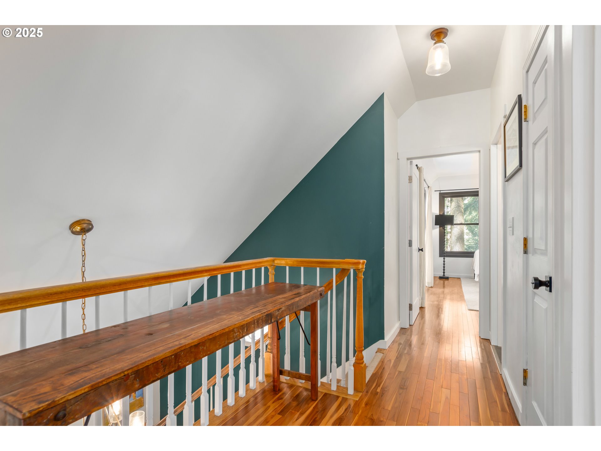 2765 Kismet Way Eugene, OR 97405 - Photo 22 of 46 a view of a hallway with wooden floor and stairs