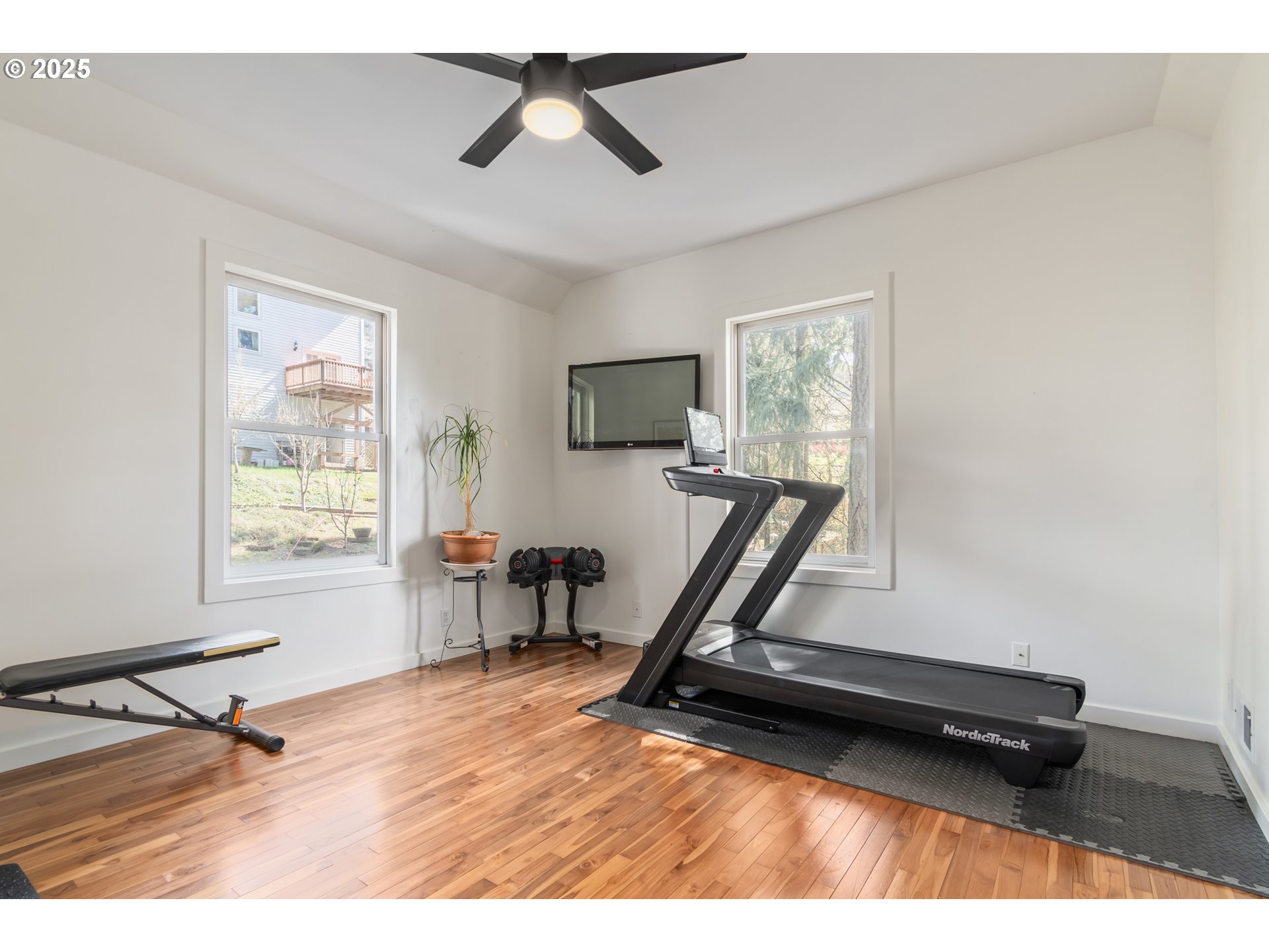 2765 Kismet Way Eugene, OR 97405 - Photo 33 of 46 a living room with a flat screen tv on the desk and wooden floor
