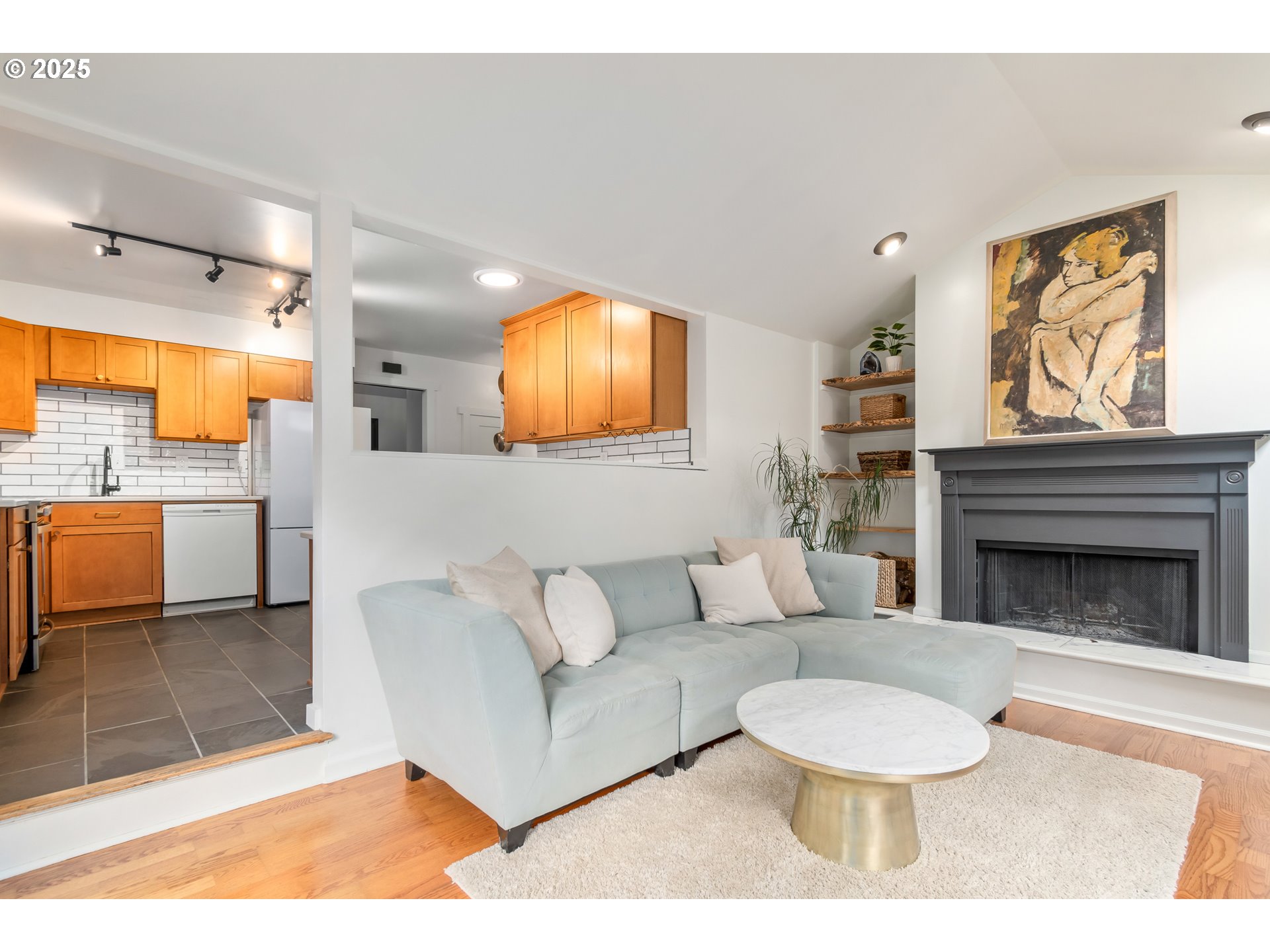 2765 Kismet Way Eugene, OR 97405 - Photo 10 of 46 a living room with furniture a fireplace and a flat screen tv