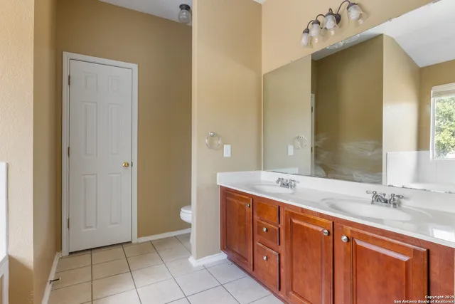 a spacious bathroom with a double vanity sink mirror and