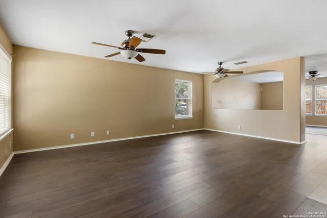 wooden floor in an empty room with a window
