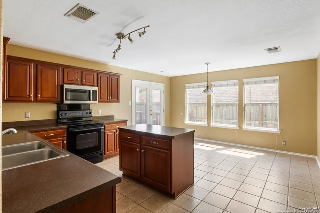 a kitchen with a stove a sink and a microwave