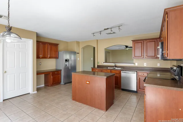 a kitchen with stainless steel appliances granite countertop a sink and cabinets