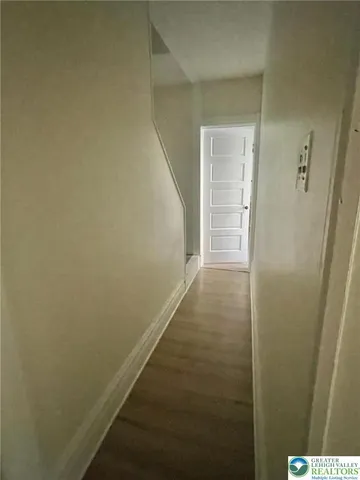 a view of a room with wooden floor