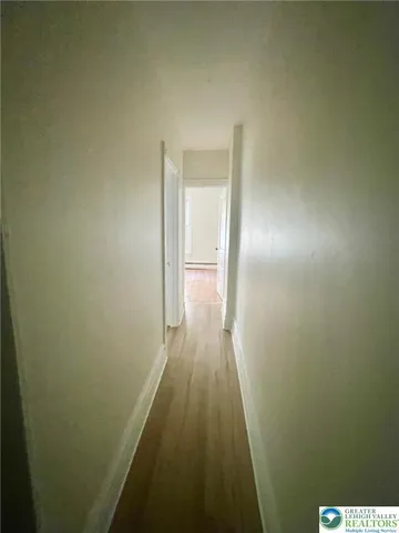 a view of a room with stairs and a chandelier