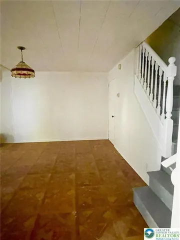 a view of room with hardwood floor and ceiling fan
