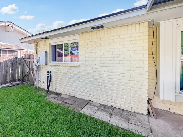 a view of a patio with table and chairs next to a yard