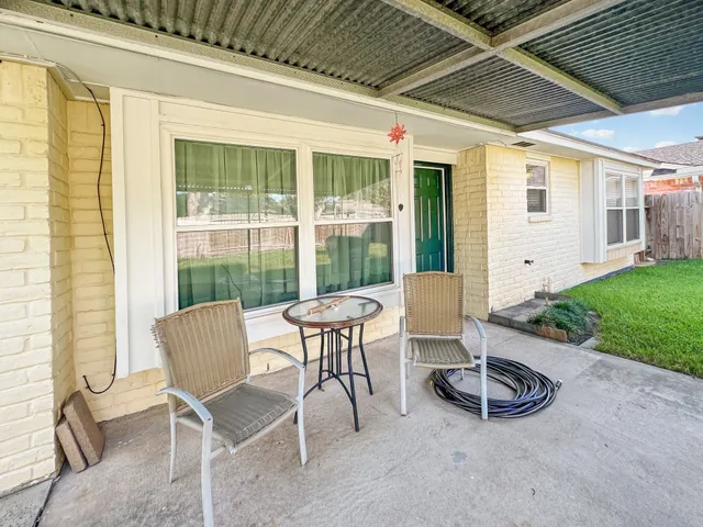 a dining room with furniture and a floor to ceiling window