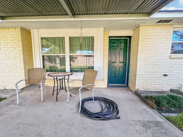 a view of a house with a big yard and large trees