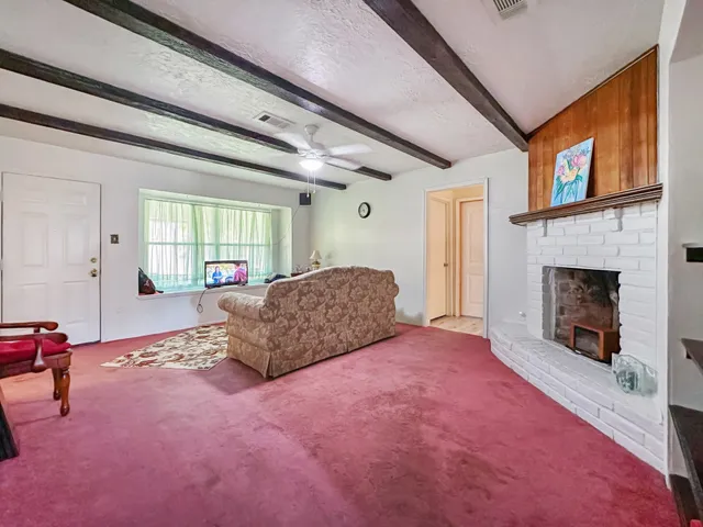 a spacious bedroom with a bed and a fireplace